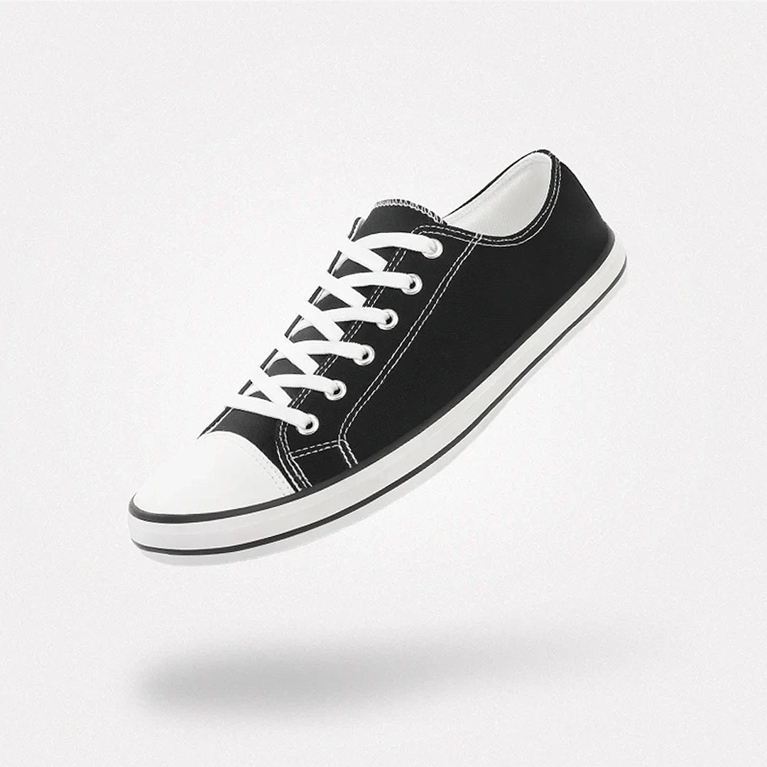 Zapatillas barefoot urbanas Saguaro Roam II en lona negra con suela flexible blanca.